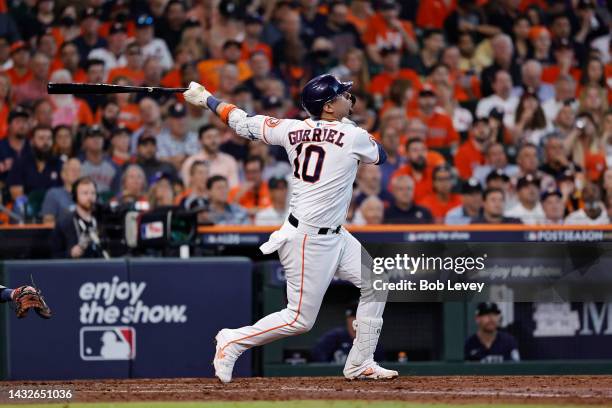 Yuli Gurriel of the Houston Astros hits a solo home run against the Seattle Mariners during the fourth inning in game one of the American League...