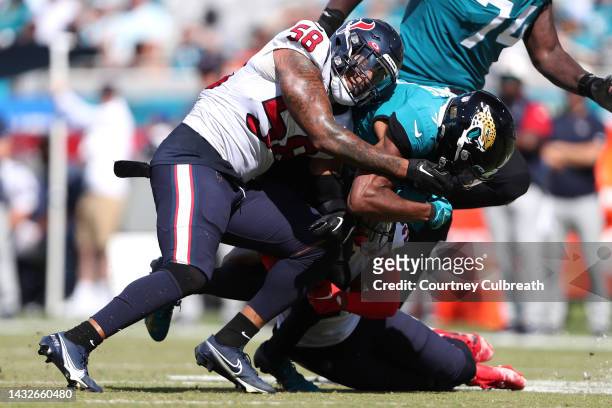 Zay Jones of the Jacksonville Jaguars is tackled by Steven Nelson and Christian Kirksey of the Houston Texans during the second half of the game at...