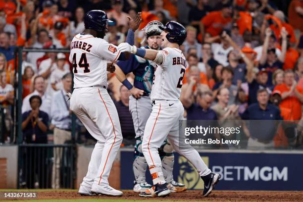 Alex Bregman of the Houston Astros celebrates his two-run home run against the Seattle Mariners with Yordan Alvarez during the eighth inning in game...