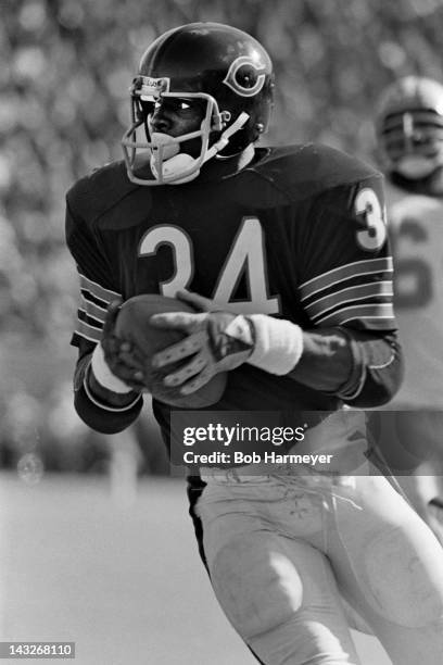 Running back Walter Payton of the Chicago Bears carries the ball against the Detroit Lions on October 19 at Soldier Field in Chigaco, Illinois.