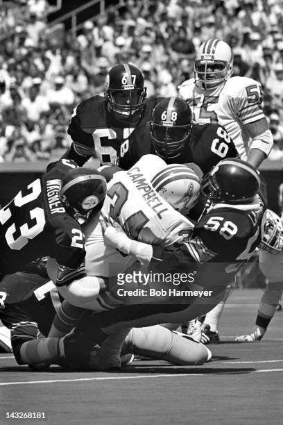 Running back Earl Campbell of the Houston Oilers is stopped by linebacker Jack Lambert and safety Mike Wagner of the Pittsburgh Steelers on September...