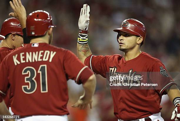 Gerardo Parra of the Arizona Diamondbacks high-fives teammates after hitting a grand slam against the Atlanta Braves during the second inning of the...