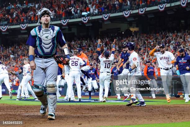Cal Raleigh of the Seattle Mariners reacts after a walk-off home run was hit by Yordan Alvarez of the Houston Astros during the ninth inning in game...