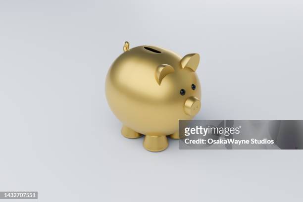 golden piggy bank over grey background - al encuentro de mr banks fotografías e imágenes de stock