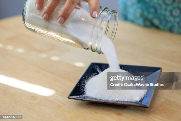 pouring white sugar from glass jar - sugar jar stock pictures, royalty-free photos & images