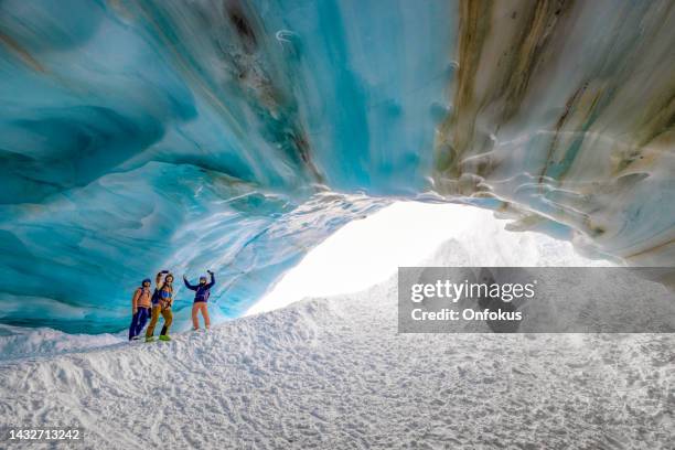 skiers standing at the entrance to ice cave in whistler, bc, canada - ice cave stock pictures, royalty-free photos & images