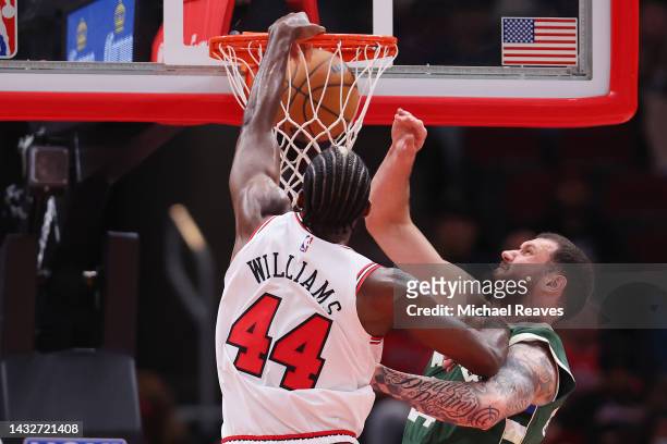 Patrick Williams of the Chicago Bulls dunks on Sandro Mamukelashvili of the Milwaukee Bucks during the first half of a preseason game at United...