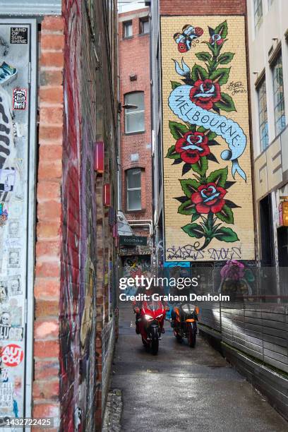 Jack Miller and Remy Gardner of Australia ride their motorcycles along Duckboard Place to ACDC Lane during a MotoGP preview media opportunity on...