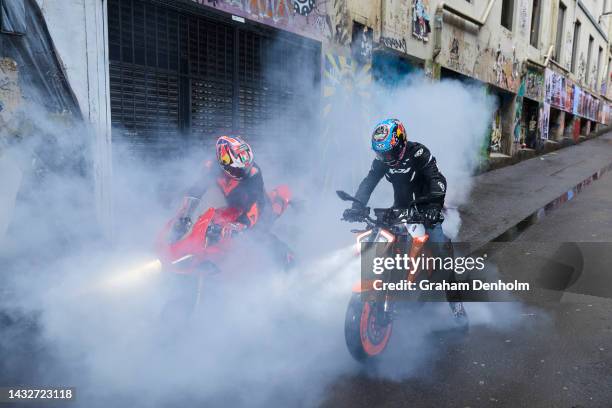 Jack Miller and Remy Gardner of Australia pose as they ride their motorcycles along Duckboard Place to ACDC Lane during a MotoGP preview media...