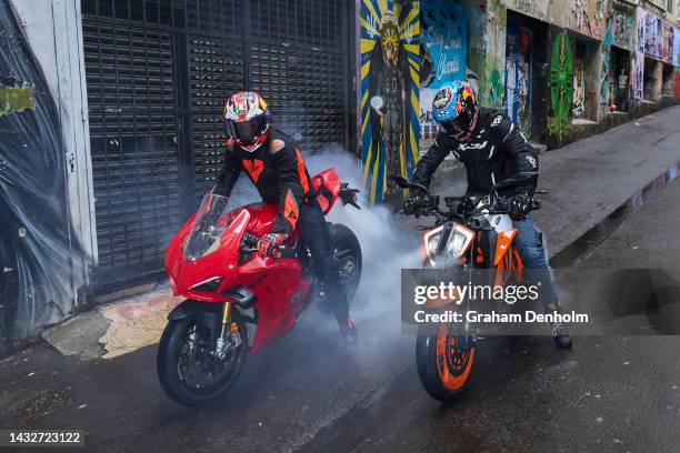 Jack Miller and Remy Gardner of Australia pose as they ride their motorcycles along Duckboard Place to ACDC Lane during a MotoGP preview media...