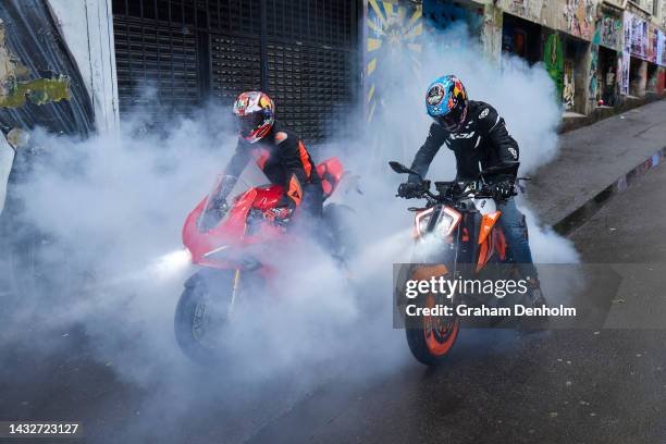 Jack Miller and Remy Gardner of Australia pose as they ride their motorcycles along Duckboard Place to ACDC Lane during a MotoGP preview media...