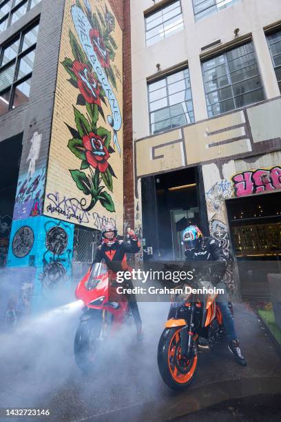 Jack Miller and Remy Gardner of Australia pose as they ride their motorcycles along Duckboard Place to ACDC Lane during a MotoGP preview media...