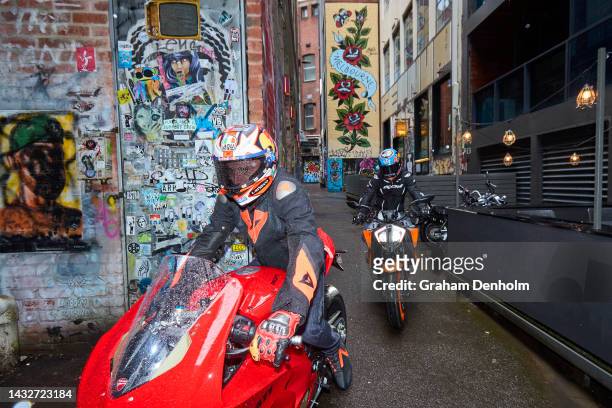 Jack Miller and Remy Gardner of Australia ride their motorcycles along Duckboard Place to ACDC Lane during a MotoGP preview media opportunity on...