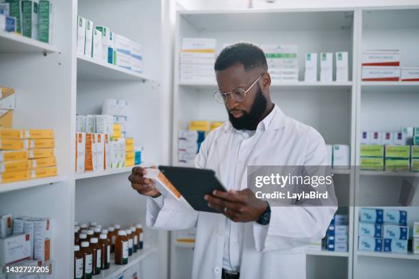 pharmacist with digital tablet and medicine for online checklist in medical storage with pills. black man, doctor or healthcare expert working in pharmacy retail store to check stock or product - black pharmacist stock pictures, royalty-free photos & images