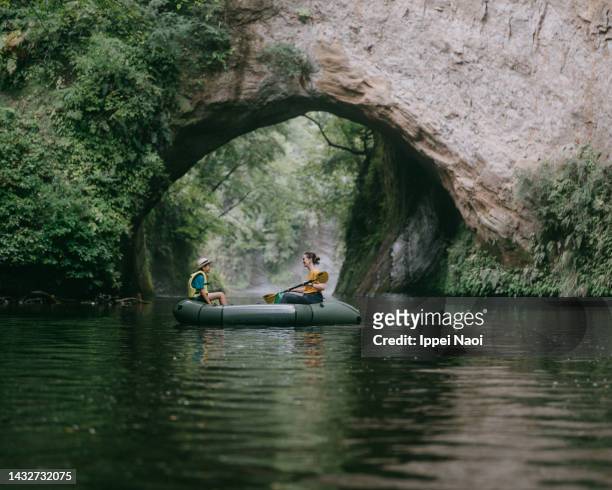 mother and child kayaking on river with cave, chiba, japan - 壮大な景観 ストックフォトと画像