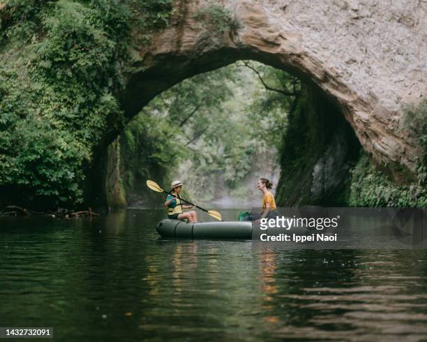 mother and child kayaking on river with cave, chiba, japan - prefectura de chiba fotografías e imágenes de stock