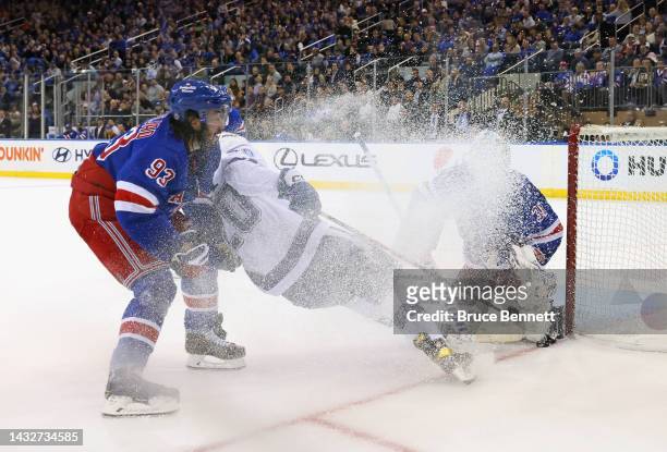 Mika Zibanejad and Igor Shesterkin of the New York Rangers defend against Nicholas Paul of the Tampa Bay Lightning during the second period at...