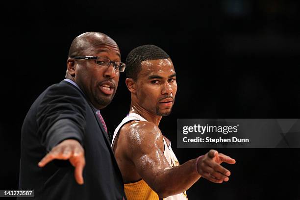 Ramon Sessions and head coach Mike Brown of the Los Angeles Lakers consult during the game with the Oklahoma City Thunder at Staples Center on April...