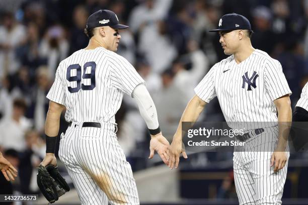 Aaron Judge and Giancarlo Stanton of the New York Yankees celebrate after defeating the Cleveland Guardians in game one of the American League...