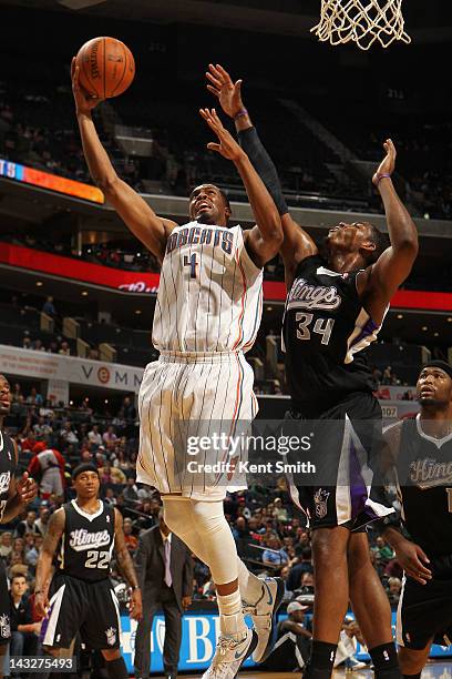 Derrick Brown of the Charlotte Bobcats shoots against Jason Thompson of the Sacramento Kings at the Time Warner Cable Arena on April 22, 2012 in...