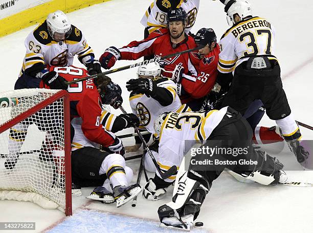 Boston Bruins goalie Tim Thomas makes a save during a scrum in front of the Bruins net during the first period. The Boston Bruins took on the...