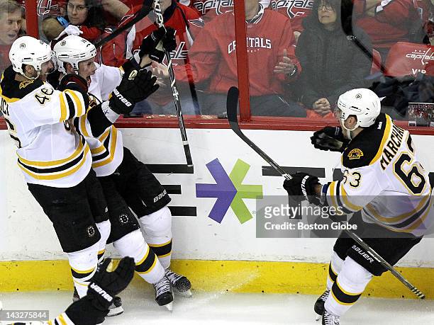 Boston Bruins center David Krejci and Boston Bruins left wing Brad Marchand join in the celebration after Seguin scored the game winner in overtime....