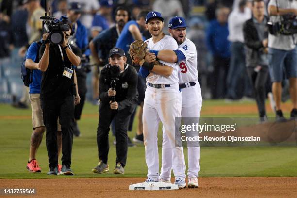 Trea Turner and Gavin Lux of the Los Angeles Dodgers celebrate a 5-3 win over the San Diego Padres in game one of the National League Division Series...