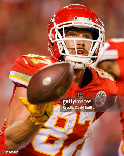 Travis Kelce of the Kansas City Chiefs tosses the football in the air after his fourth touchdown catch of the game against the Las Vegas Raiders at...