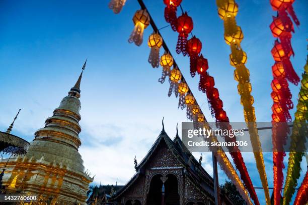 colorful lighting lantern festival against blue twilight sky at hariphunchai temple near lamphun province northern thailand - king of cambodia stock-fotos und bilder