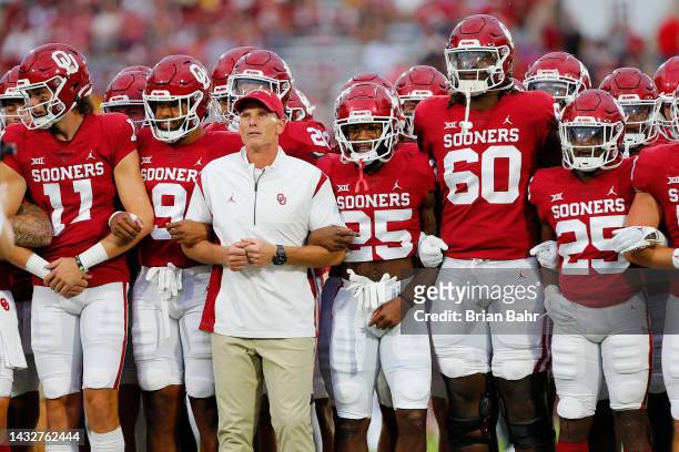 Head coach Brent Venables and the Oklahoma Sooners march to the end zone arm in arm before a game against the Kansas State Wildcats at Gaylord Family...