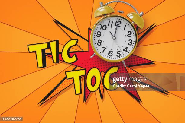 alarm clock with tik tok text - orange alarm clock stock pictures, royalty-free photos & images