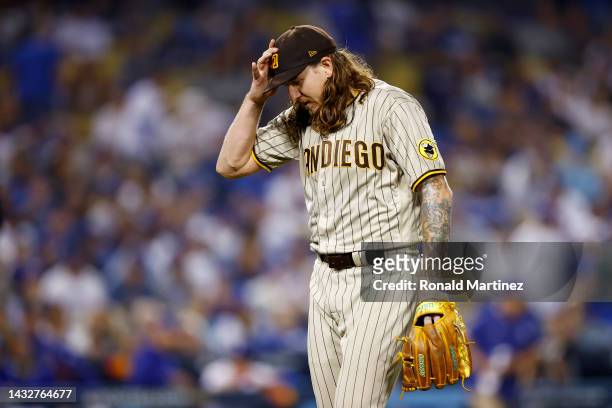 Mike Clevinger of the San Diego Padres walks off the mound at the end of the second inning in game one of the National League Division Series against...