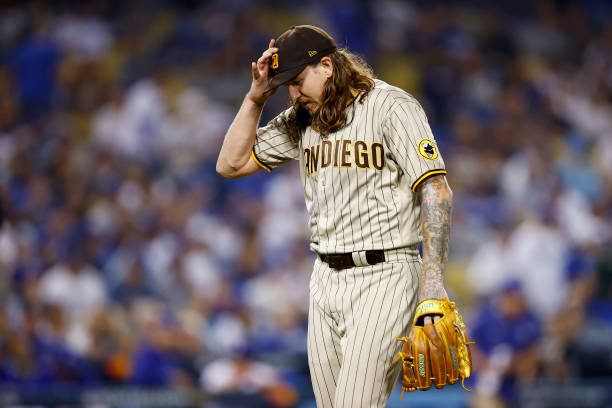 Mike Clevinger of the San Diego Padres walks off the mound at the end of the second inning in game one of the National League Division Series against...
