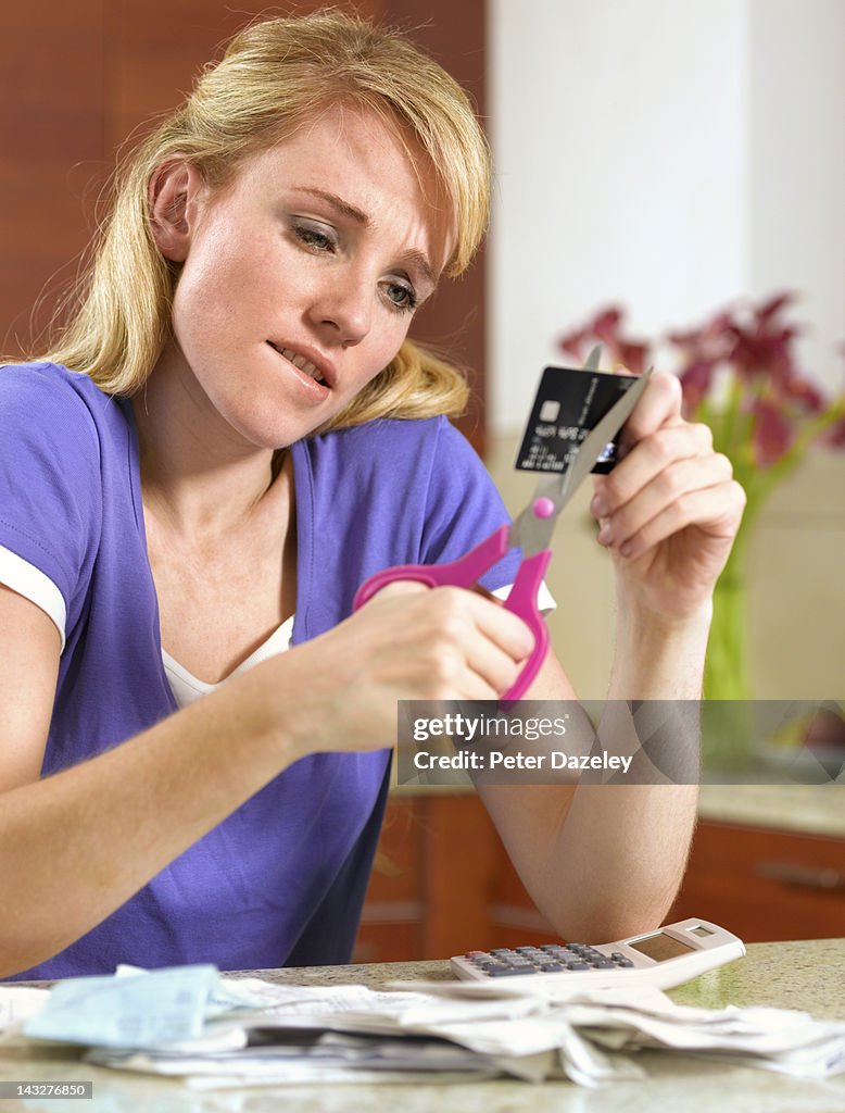 21 year old in debt cutting up a credit card