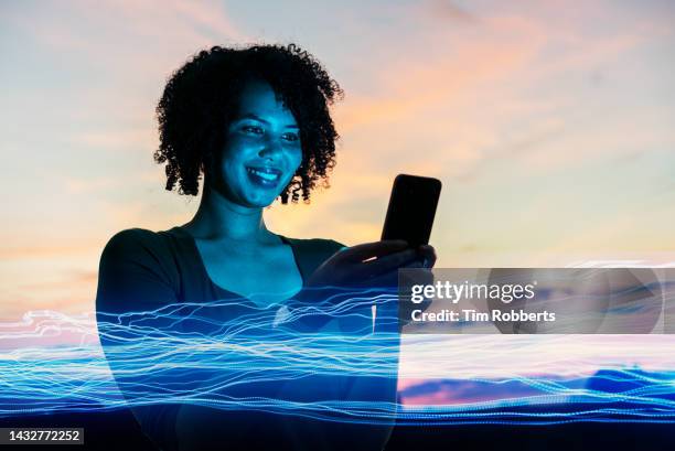 woman using smart phone with digital light - like ai stock pictures, royalty-free photos & images