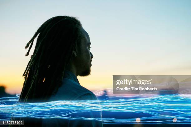 man looking ahead with light streak - light trail people stock pictures, royalty-free photos & images