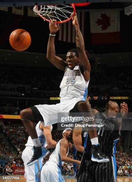 Kenneth Faried of the Denver Nuggets dunks the ball against Glen Davis of the Orlando Magic at Pepsi Center on April 22, 2012 in Denver, Colorado....