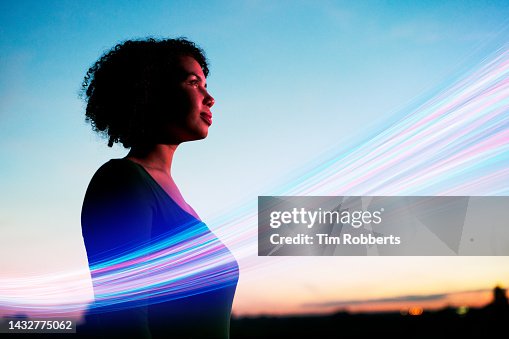 Woman looking ahead with light streak Woman looking ahead with light streak