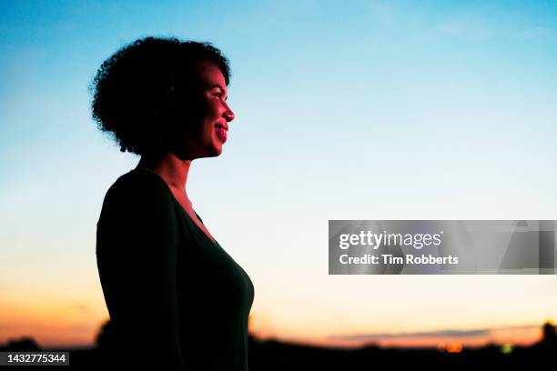 smiling woman at sunset - portrait waist up stock pictures, royalty-free photos & images