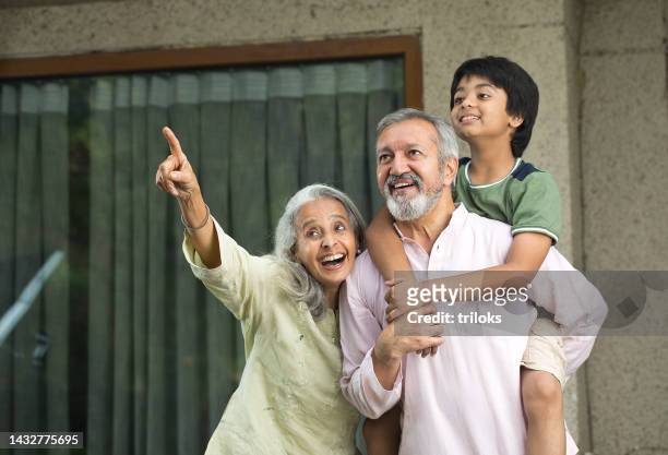 grandparents having fun with grandson at home - indian grandparents stock pictures, royalty-free photos & images