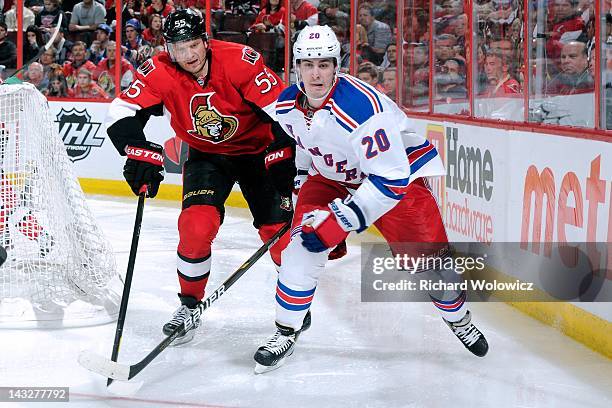 Chris Kreider of the New York Rangers and Sergei Gonchar of the Ottawa Senators chase the puck into the corner in Game Three of the Eastern...