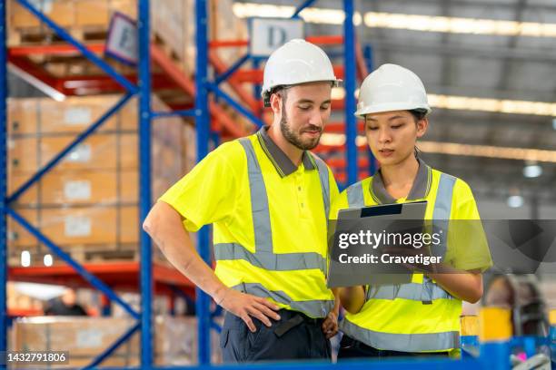 teamwork of warehouse officer in warehouse operation is working in a distribution warehouse to manage overall operations and order management to support customer satisfaction. - testmatch stockfoto's en -beelden