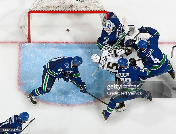 Brad Richardson of the Los Angeles Kings scores the tying goal against Cory Schneider of the Vancouver Canucks despite checking of Alexander Edler,...