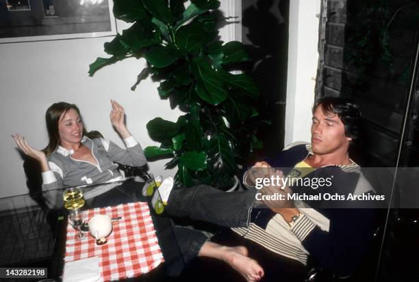 Austrian Bodybuilder Arnold Schwarzenegger plays with his girlfriends foot in April 1977 in Los Angeles, California.