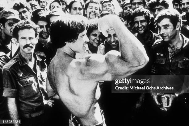 Bodybuilder Arnold Schwarzenegger shows off his biceps to IDF soldiers in 1977 in Israel.