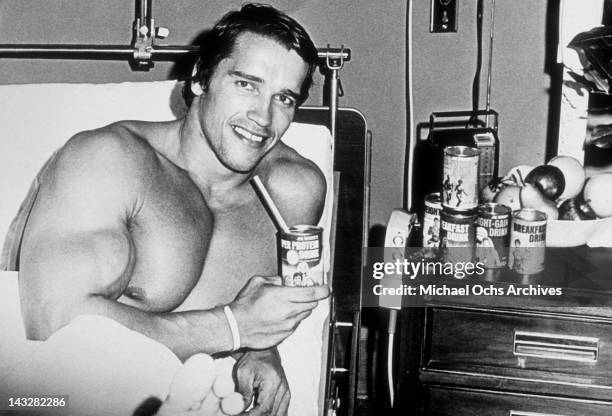 Young bodybuilder Arnold Schwarzenegger recovers from an accident during a competition circa 1967 in Munich, West Germany.