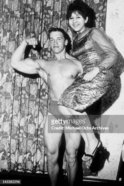 Eighteen year old bodybuilder Arnold Schwarzenegger lifts a friend in 1965 in Thal, Austria.