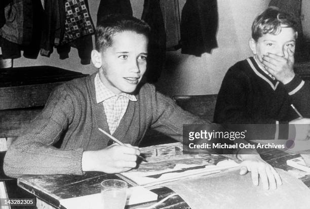 Eleven year old Arnold Schwarzenegger poses for a photo in art class in 1958 in Thal, Austria.