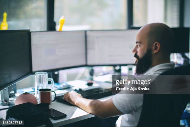 computer programmer working on new software program. - computer programmer man stock pictures, royalty-free photos & images