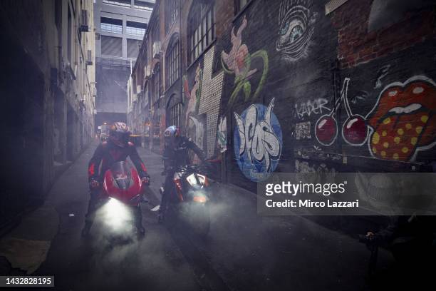 Jack Miller of Australia and Ducati Lenovo Team and Remy Gartner of Australia and Tech3 KTM Factory Racing ride the bikes along Duckboard Place to...
